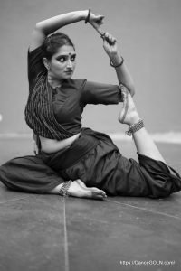 A Bharatanatyam dancer striking a pose during practice